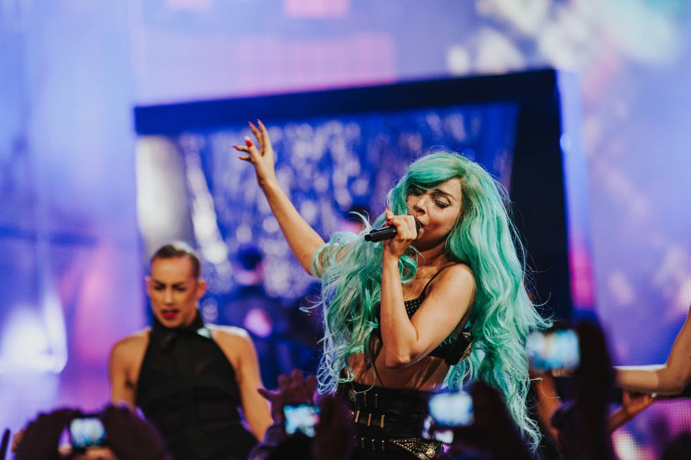 Lady Gaga with teal hair performs live with her backup dancers at the Much Music Video Awards.