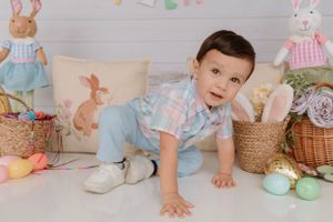 Spring photo setup with pastel eggs, bunny decorations and woven baskets.