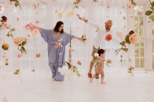 Ethereal studio photo with hanging floral decorations and soft lighting.