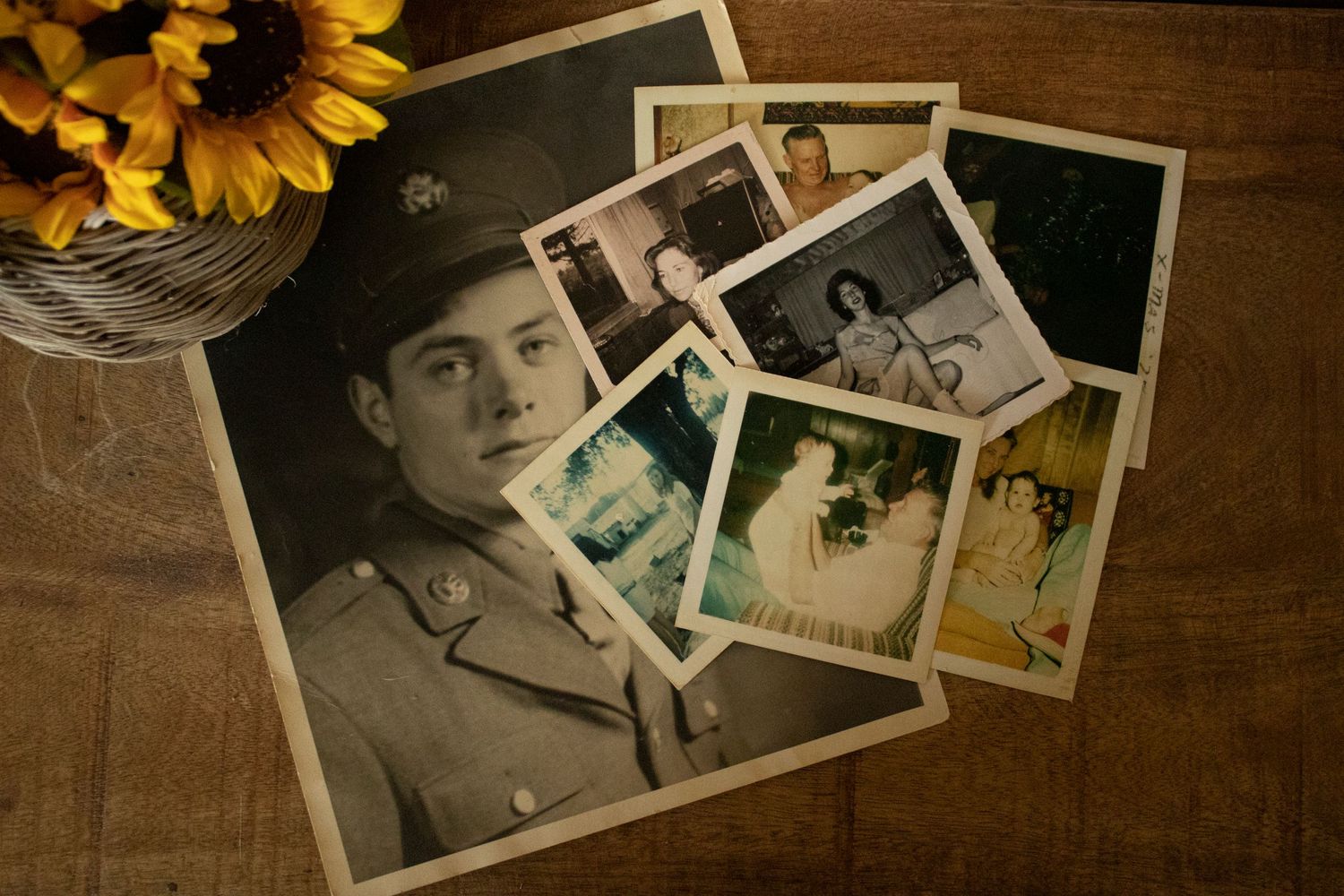 pictures scarred on a table next to some sundflowers