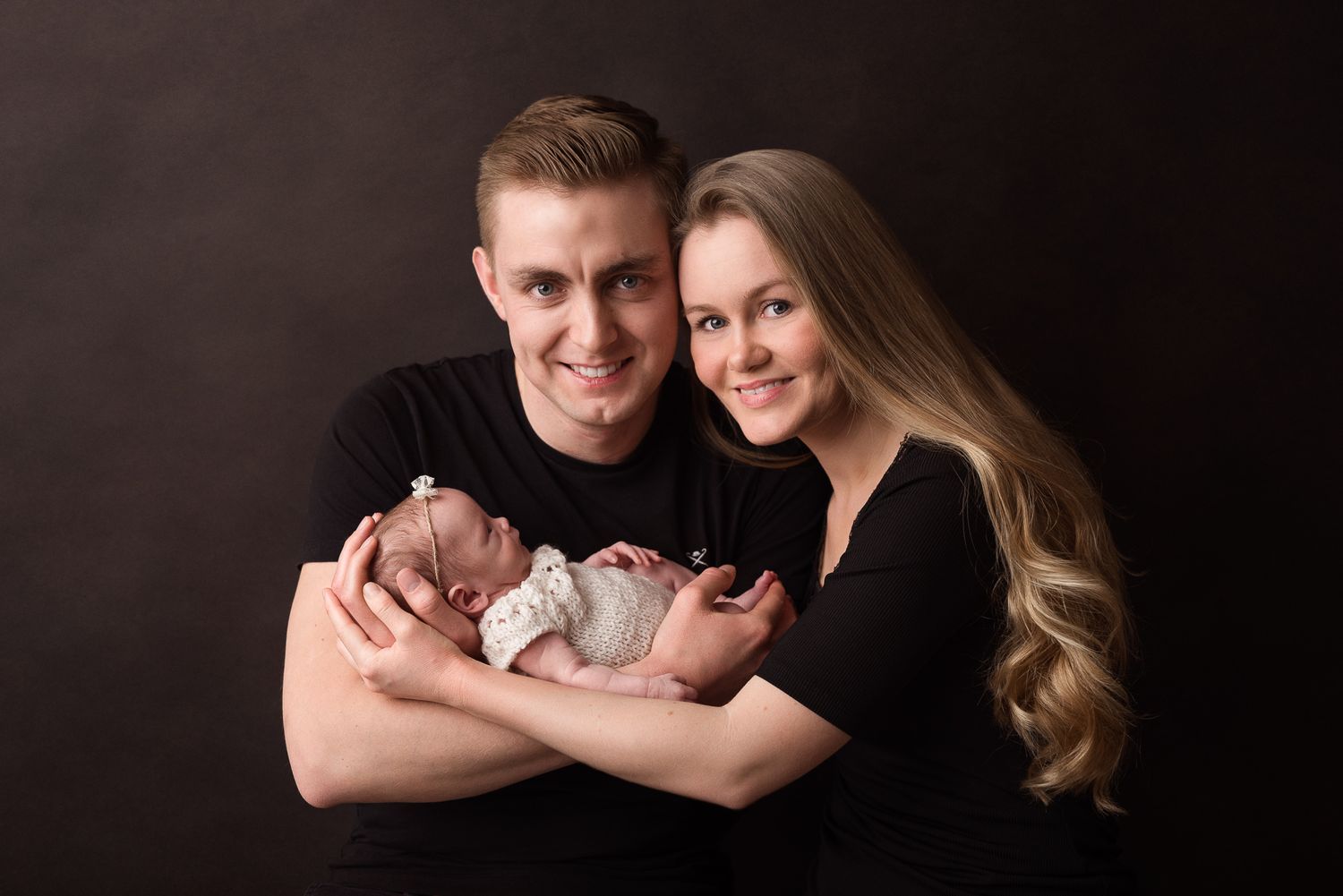 newborn baby in parents hands