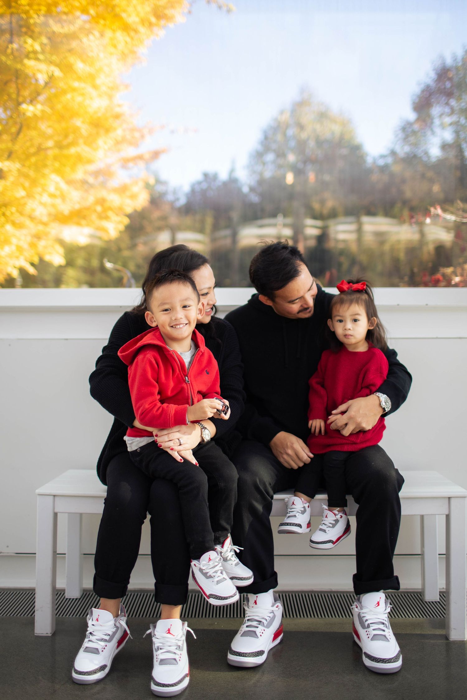Seattle Center Family photo shoot: a family of four sitting inside the Chihuly garden and glass museum at the Seattle center