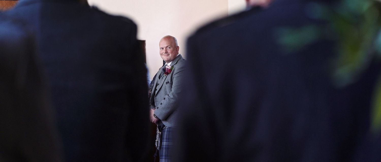wedding groom sees his bride for the first time as she comes down the aisle - cherry tree films emotional wedding