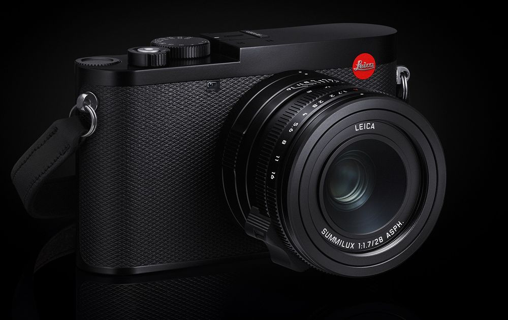 Black Leica Q2 digital camera with prime lens against dark background.
