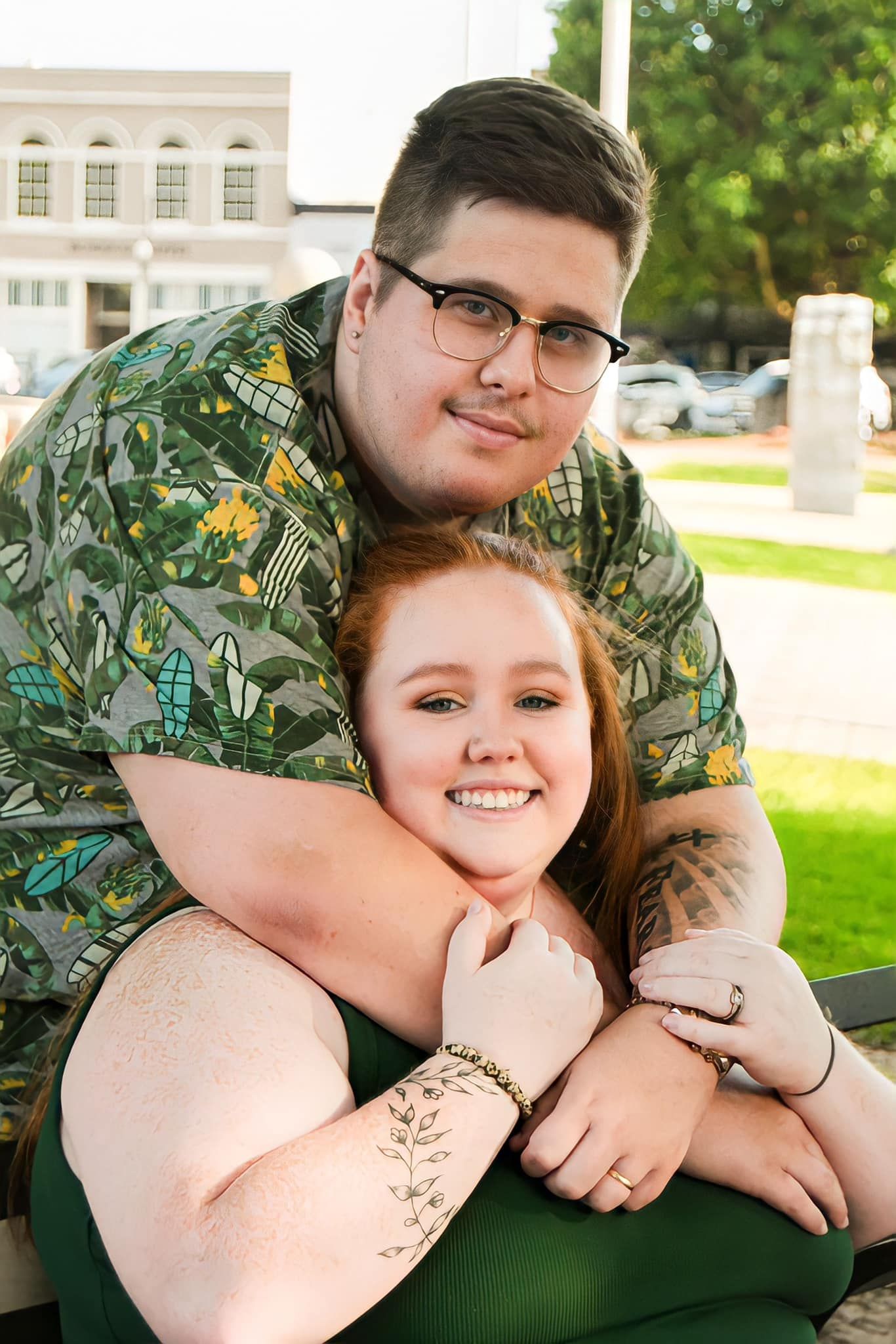Casual engagement photos of couple in relaxed poses outdoors.