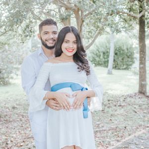 A romantic outdoor photoshoot in a garden setting with soft natural lighting.