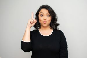 Woman in black top displaying various expressive poses against light backdrop.