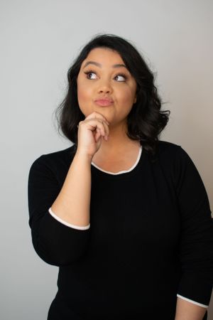 Woman in black dress with white collar showing contemplative expressions in portrait series.