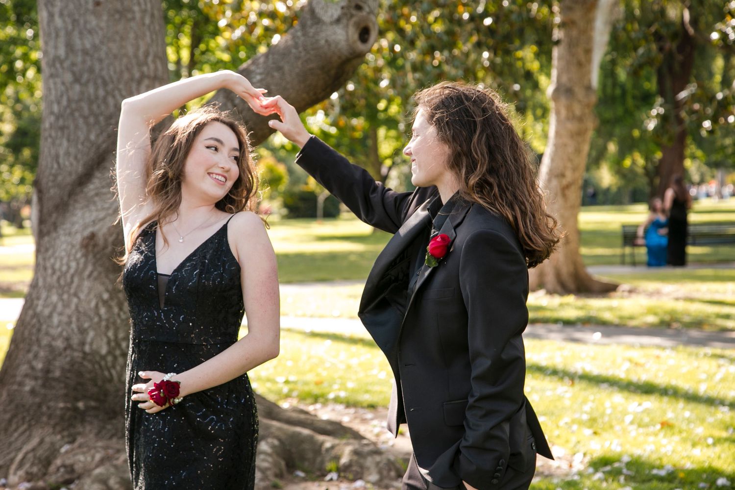 prom couple both wearing black spinning and looking at each other