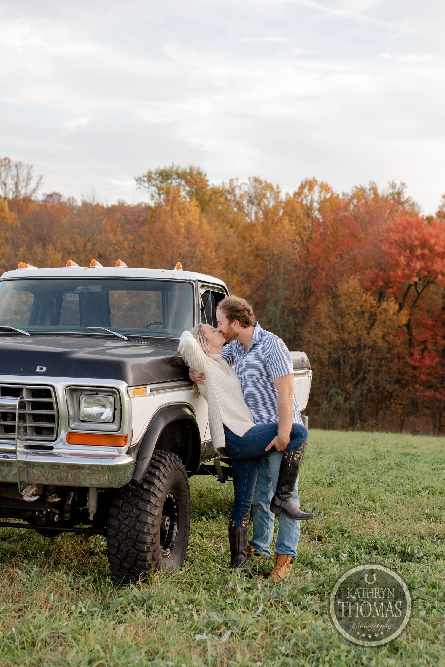 Romantic autumn photoshoot with lifted vintage Ford truck in background during golden hour.
