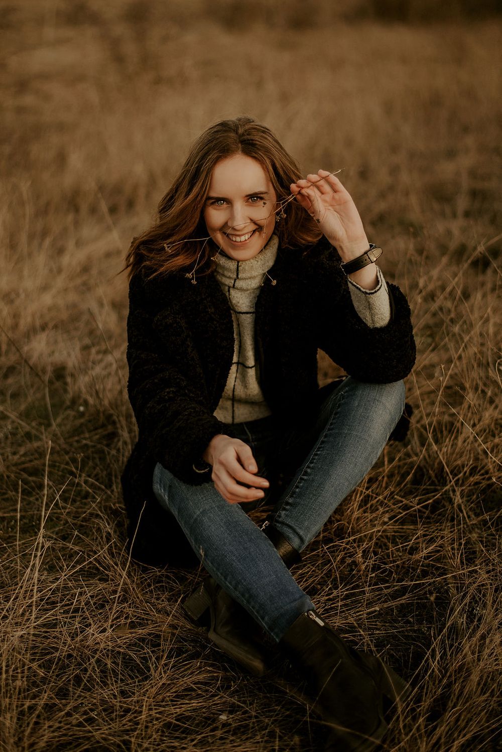 Candid outdoor photography session in a field with autumn tones.