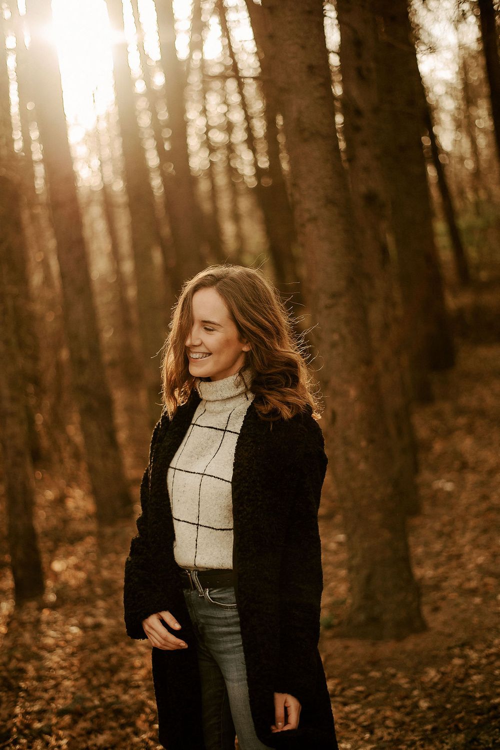 Natural light portrait in forest setting with casual autumn attire.