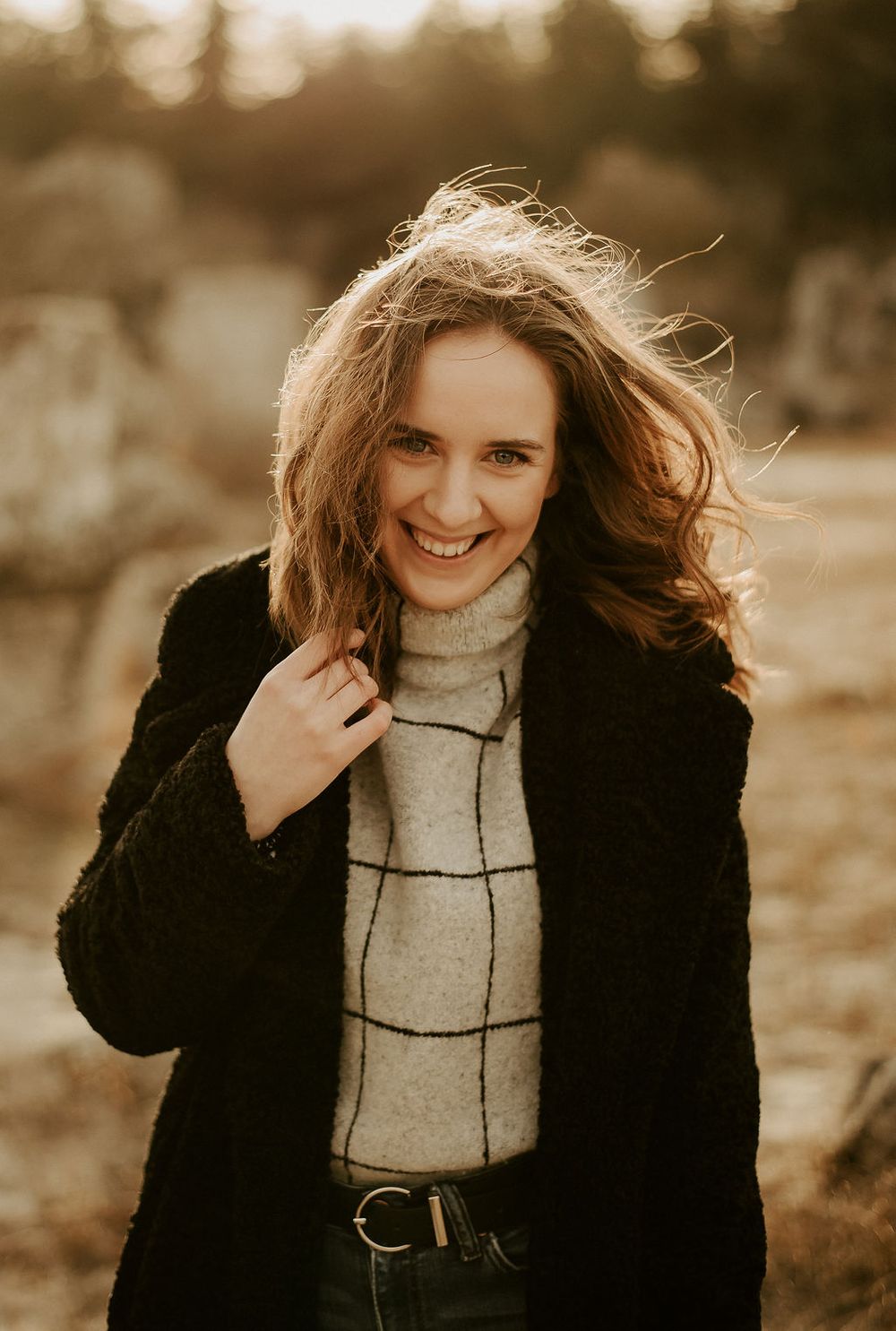 Warm-toned outdoor photography series showing playful expressions and winter fashion.