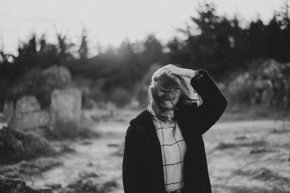 Minimalist outdoor fashion series featuring windowpane sweater and natural lighting.