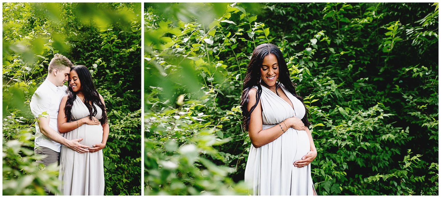 pregnant woman cradling her belly surrounded by natural green bushes
