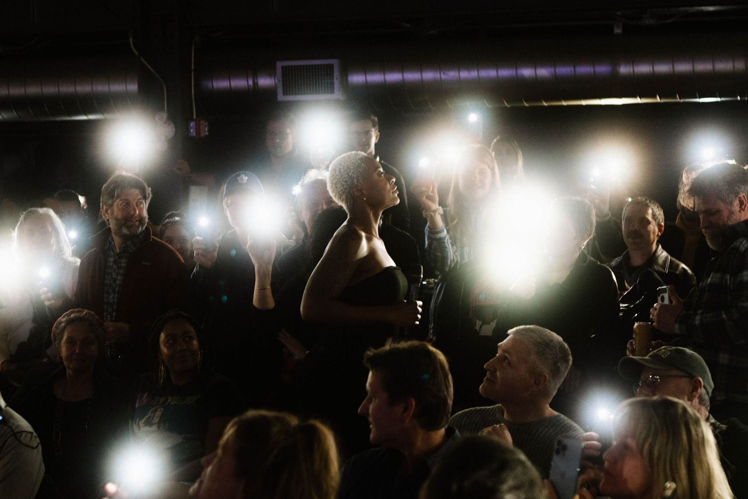 Concert crowd silhouette with dramatic backlighting creating a sea of light effects in Kitchener Ontario
