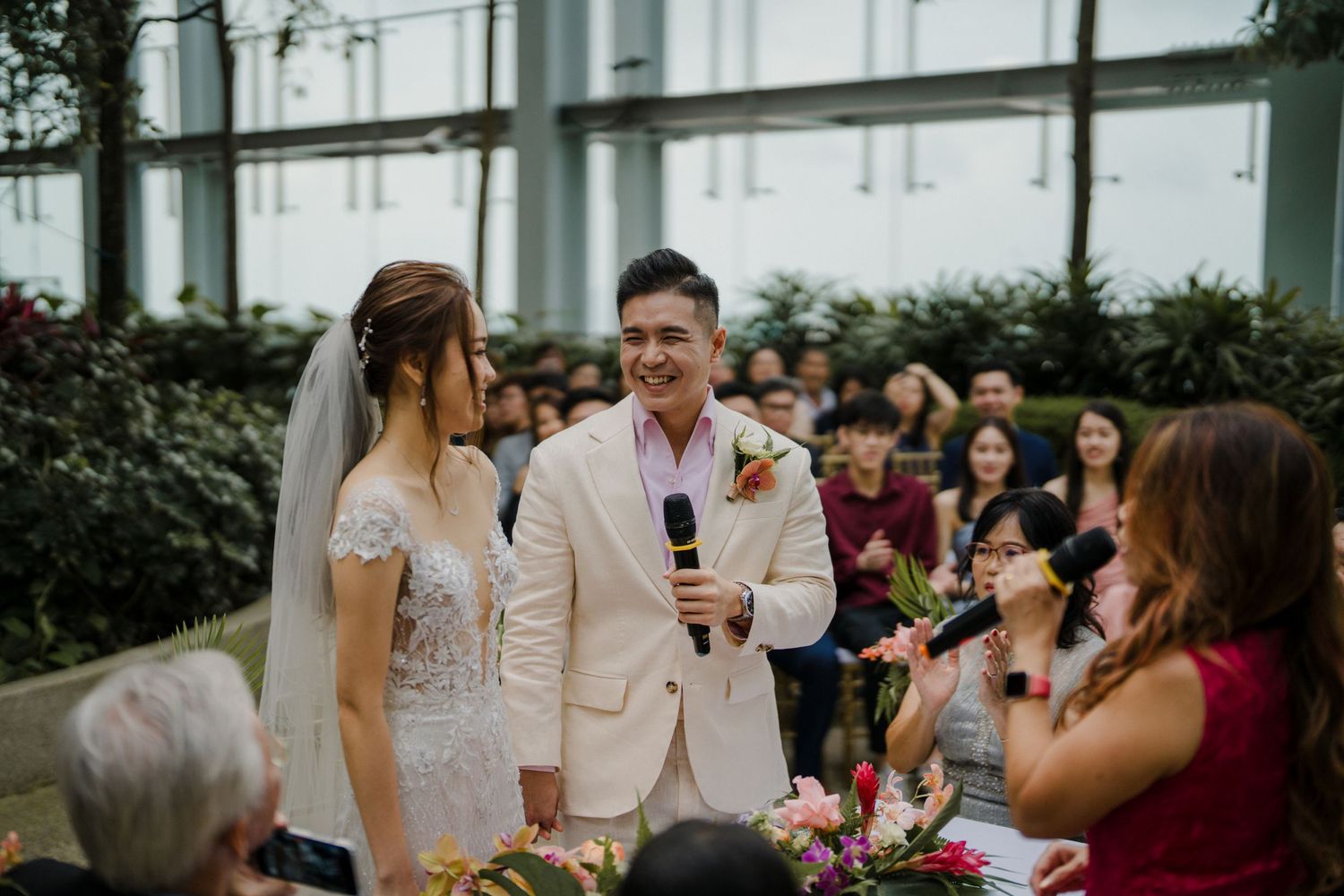 Garden wedding ceremony setup with white chairs and colorful floral arrangements.