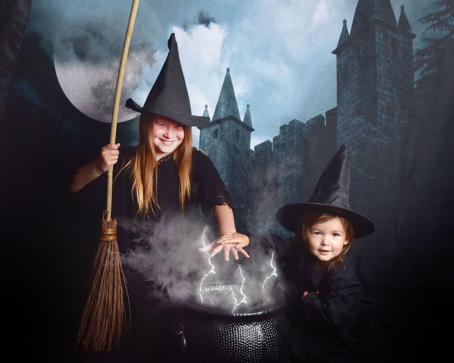 Atmospheric Halloween witch scene with cauldron and castle silhouettes in blue misty lighting.