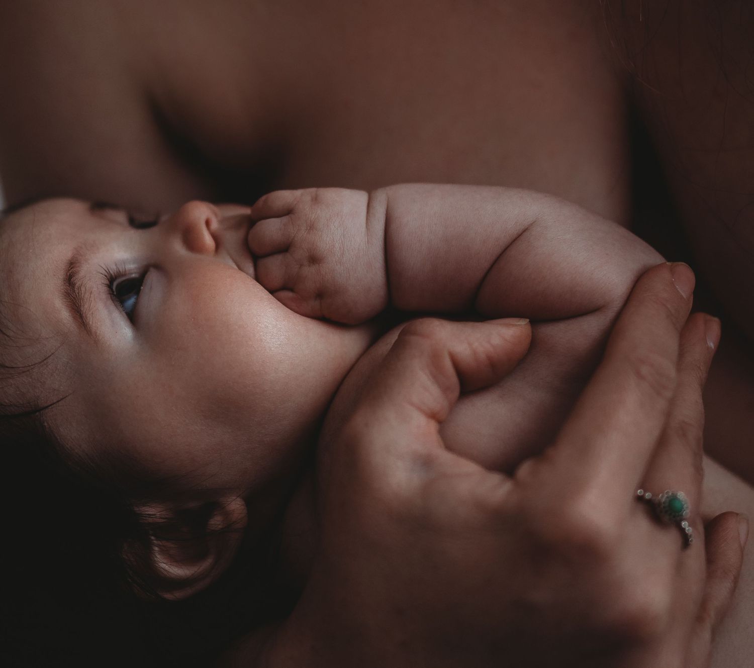 Intimate newborn photography session with soft natural lighting and gentle poses.
