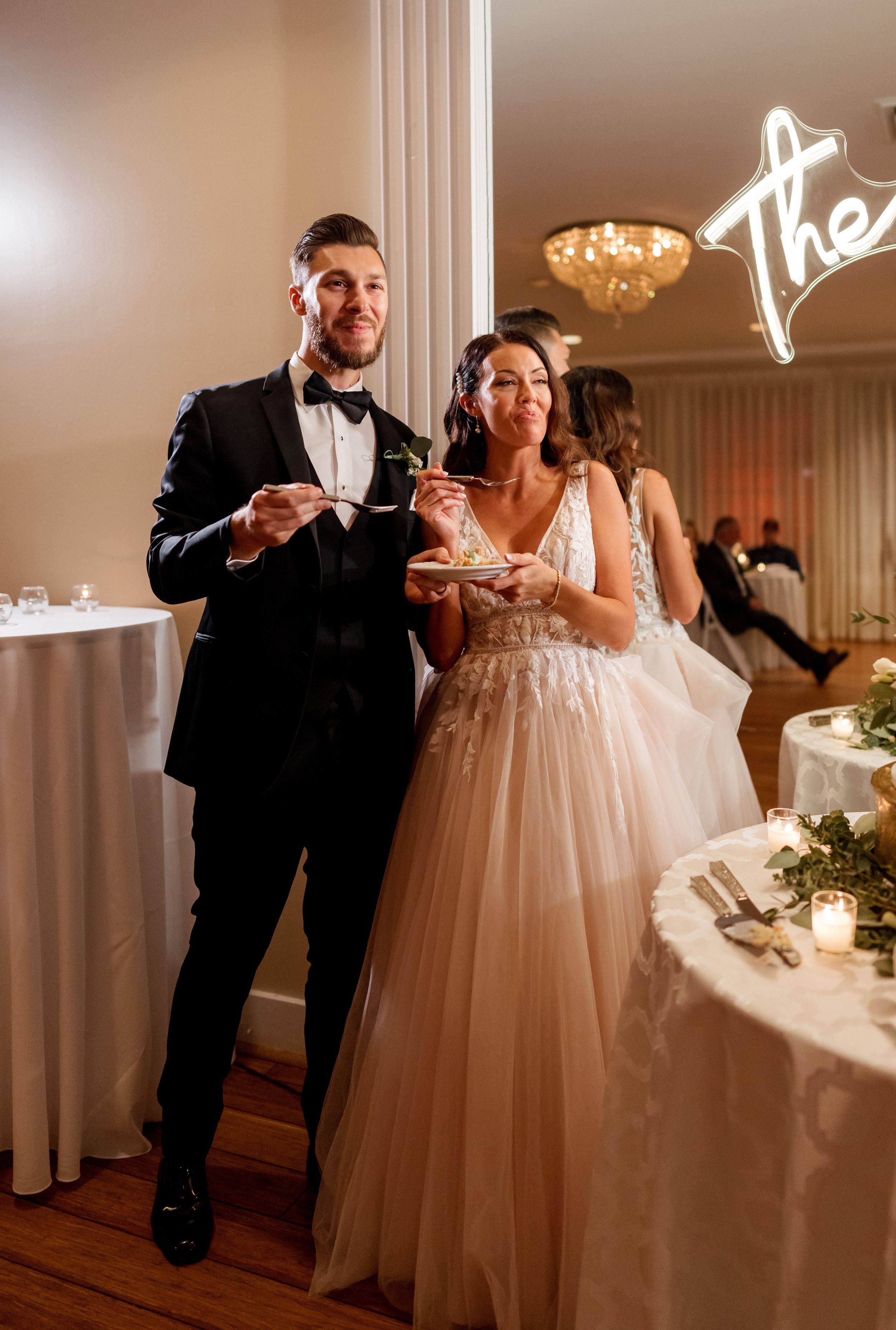 Wedding couple shares cake tasting moment at reception.