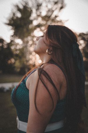 Silhouette of person in athletic wear against sunset in outdoor setting.