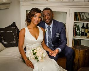 Newlyweds share romantic moments in an indoor setting with white decor.