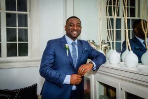 Wedding portraits taken in an elegant room with white walls and large windows.