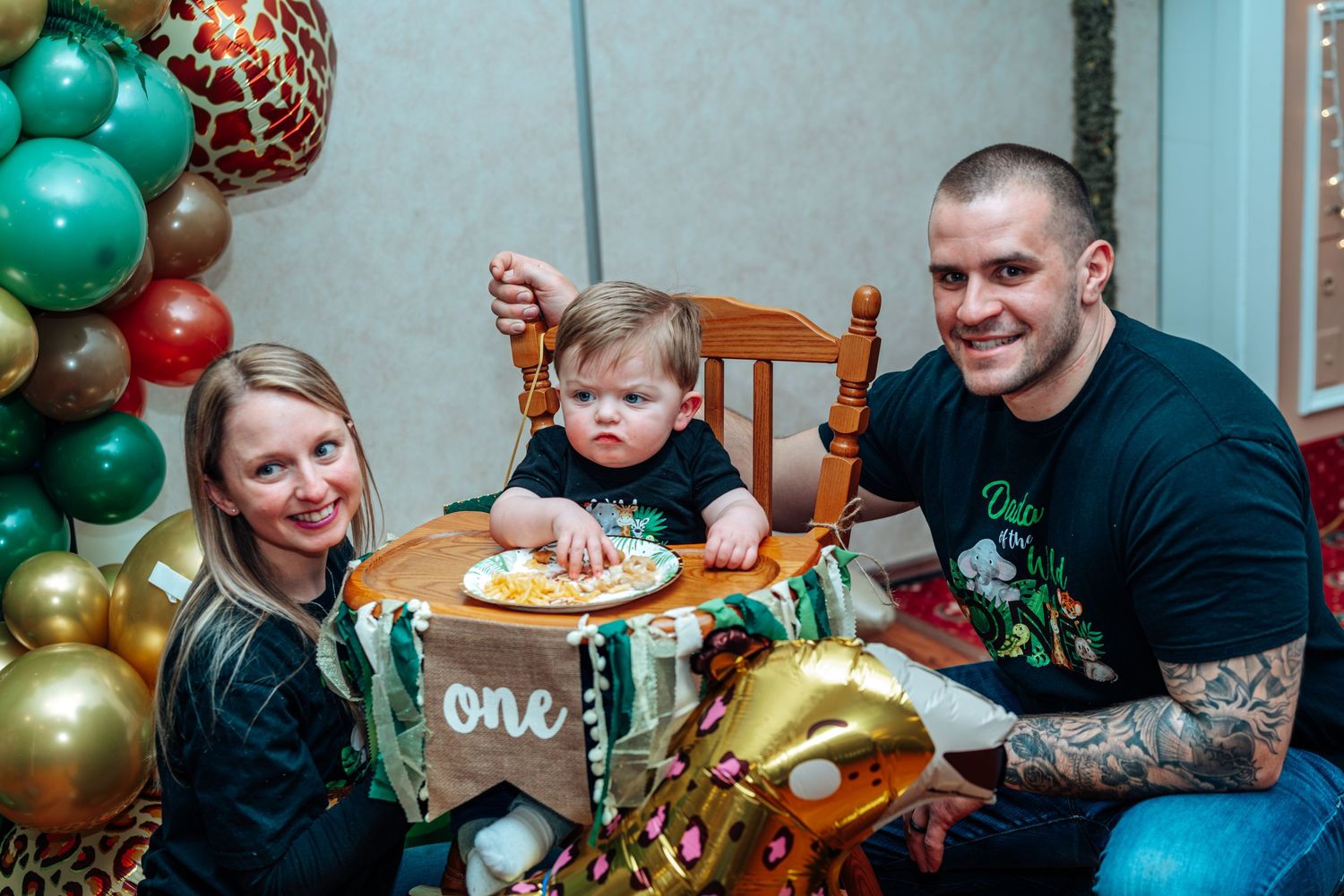First birthday celebration with colorful balloon decorations and high chair setup.