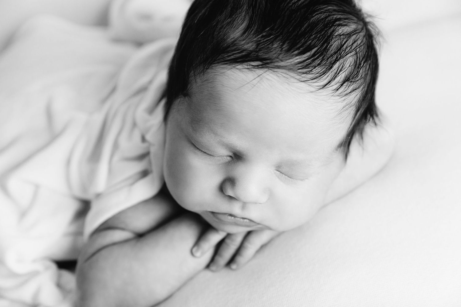 black and white image of baby boy sleeping