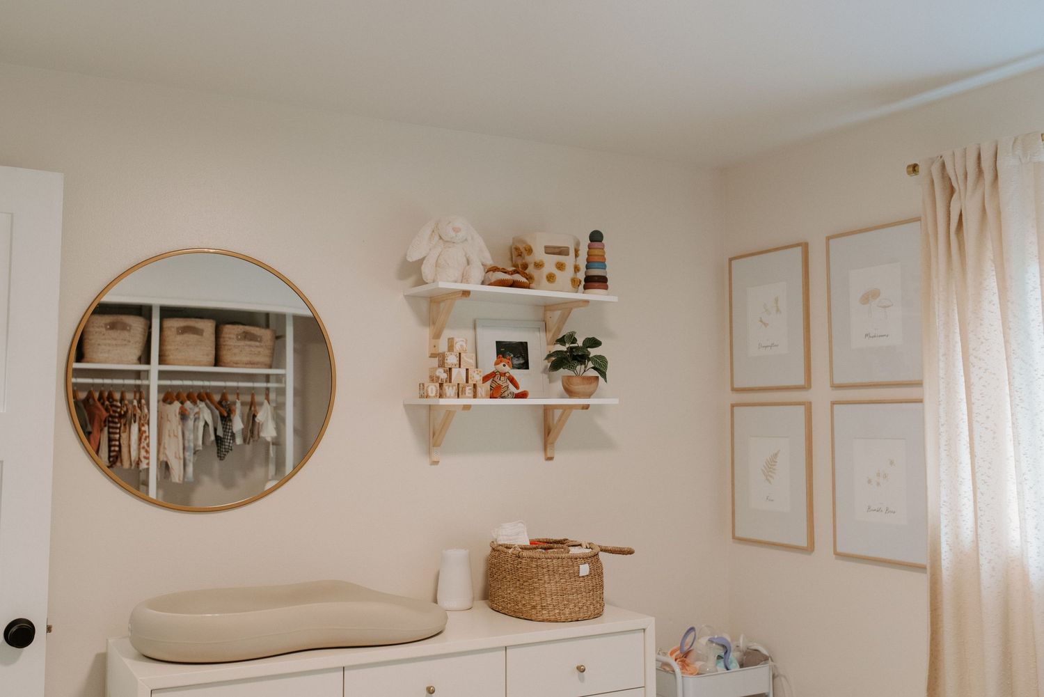 Neutral-toned nursery with wooden crib, woven baskets, and minimalist wall decor in a cozy arrangement.