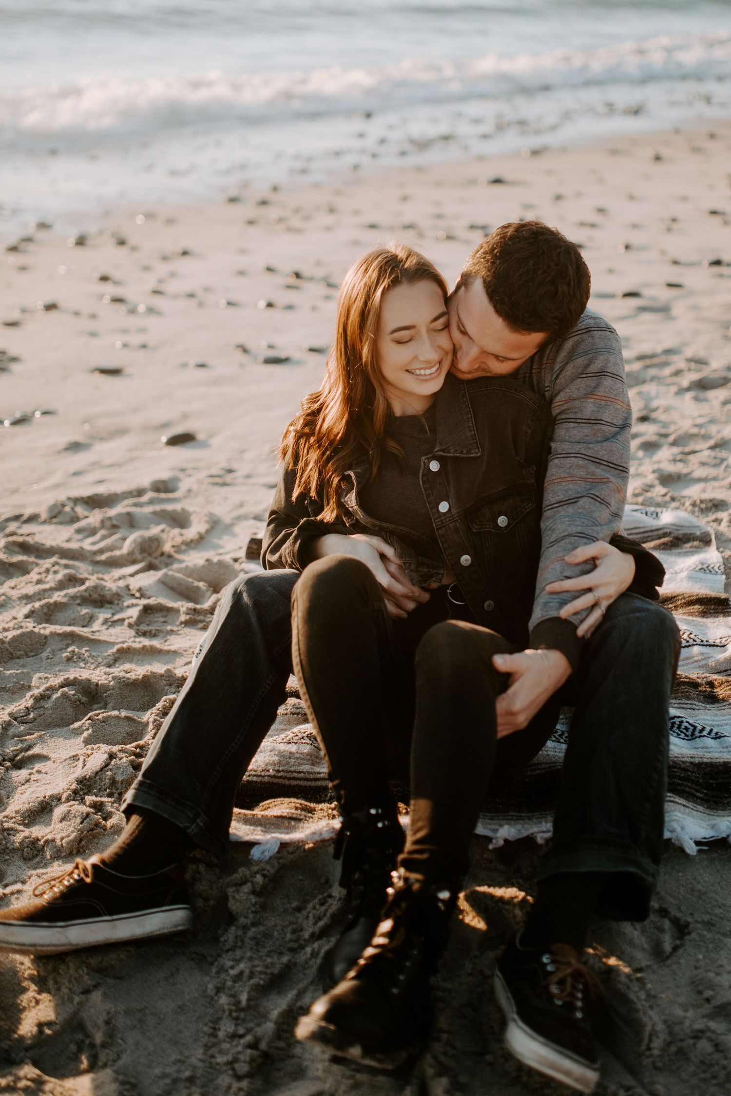 A tender beach sunset moment captured on the sandy shore.
