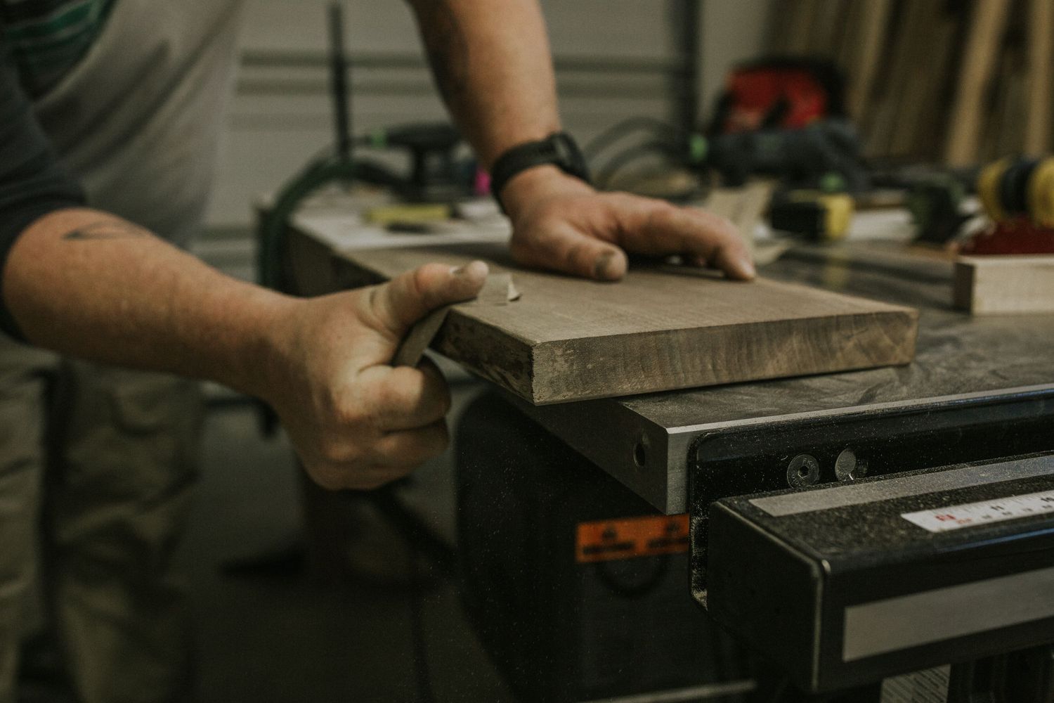 man sanding wood.