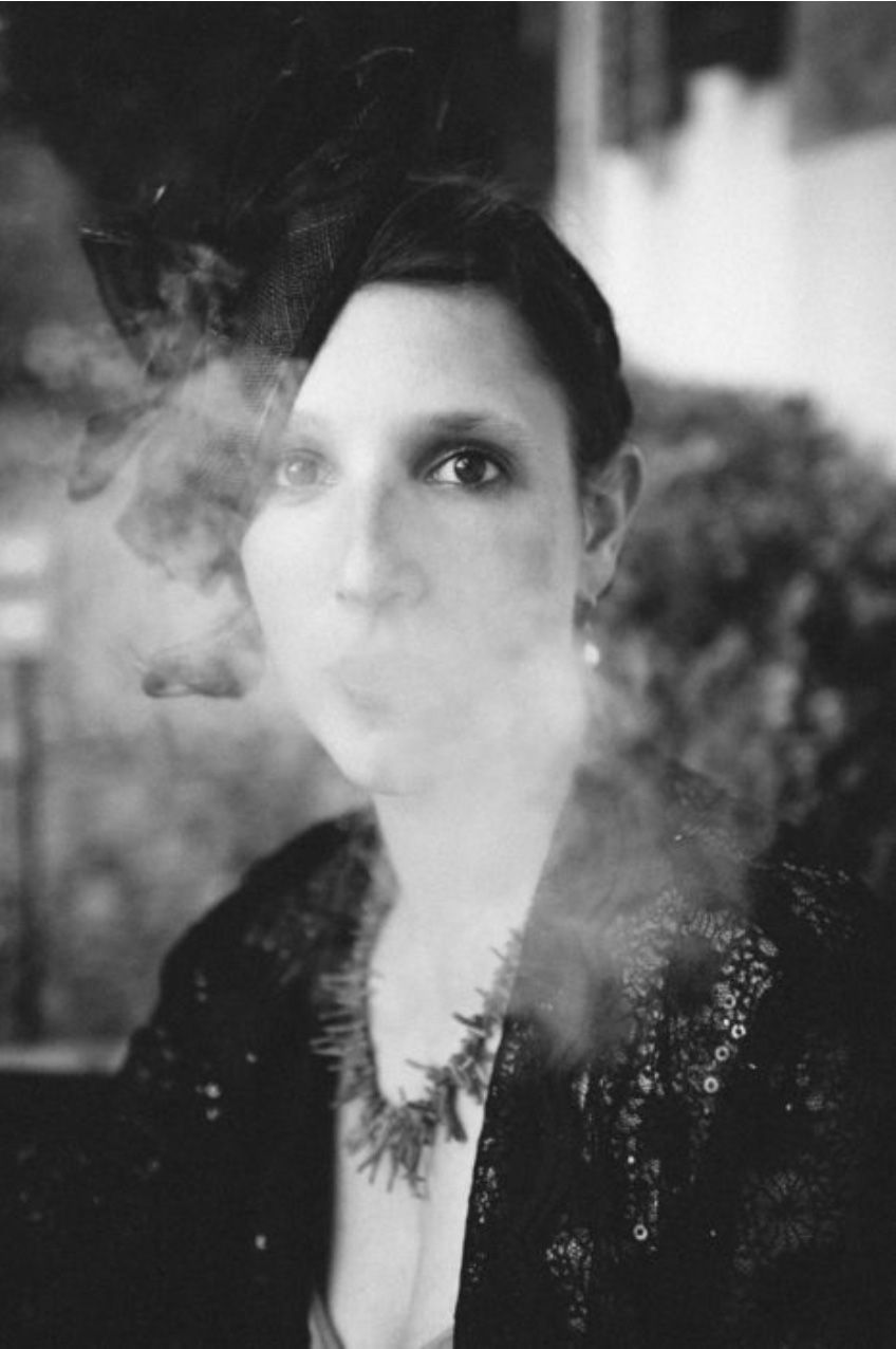 Artistic black and white portrait with smoke creating a dreamy atmosphere.