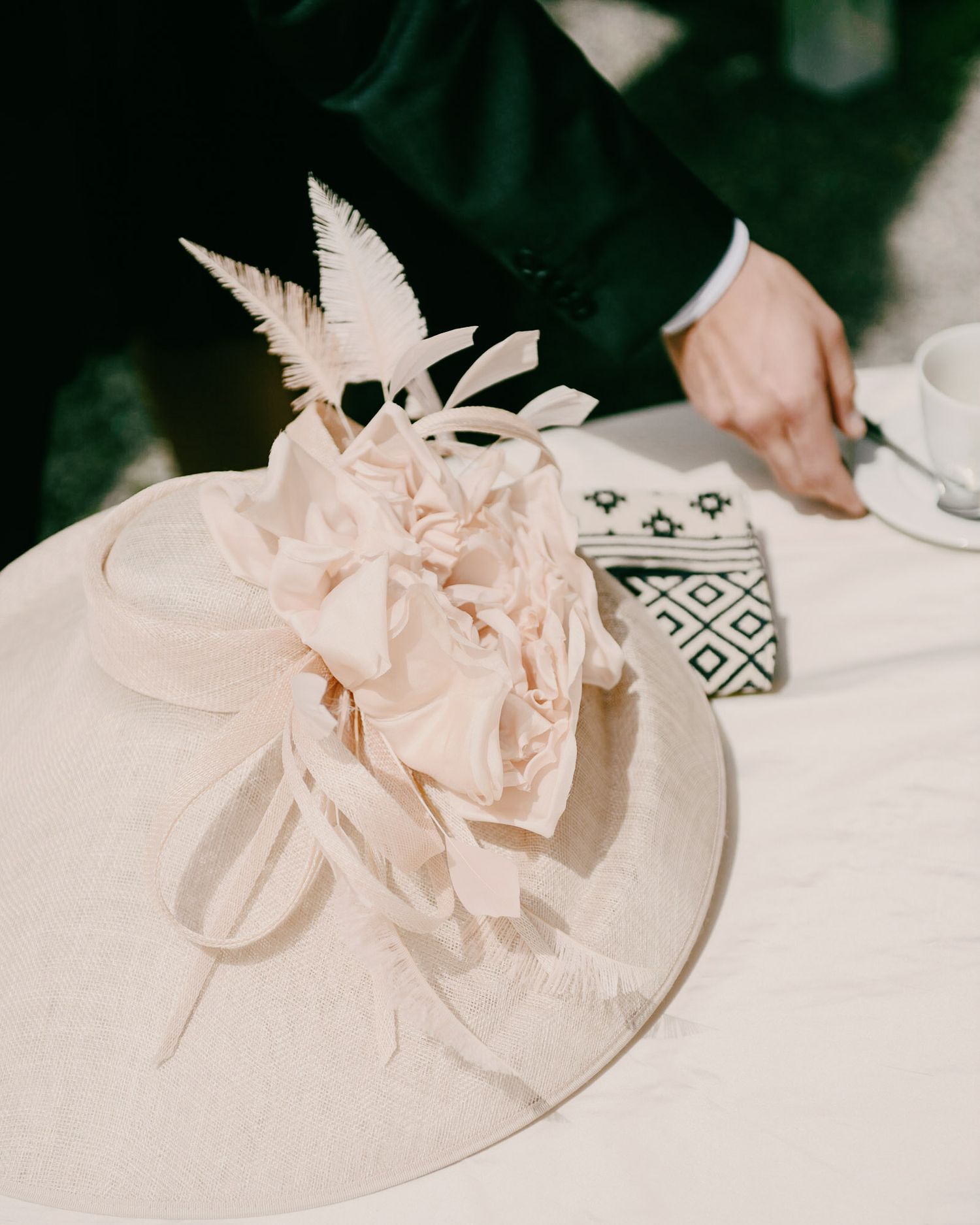 Delicate pale pink floral arrangements displayed on a white tablecloth.