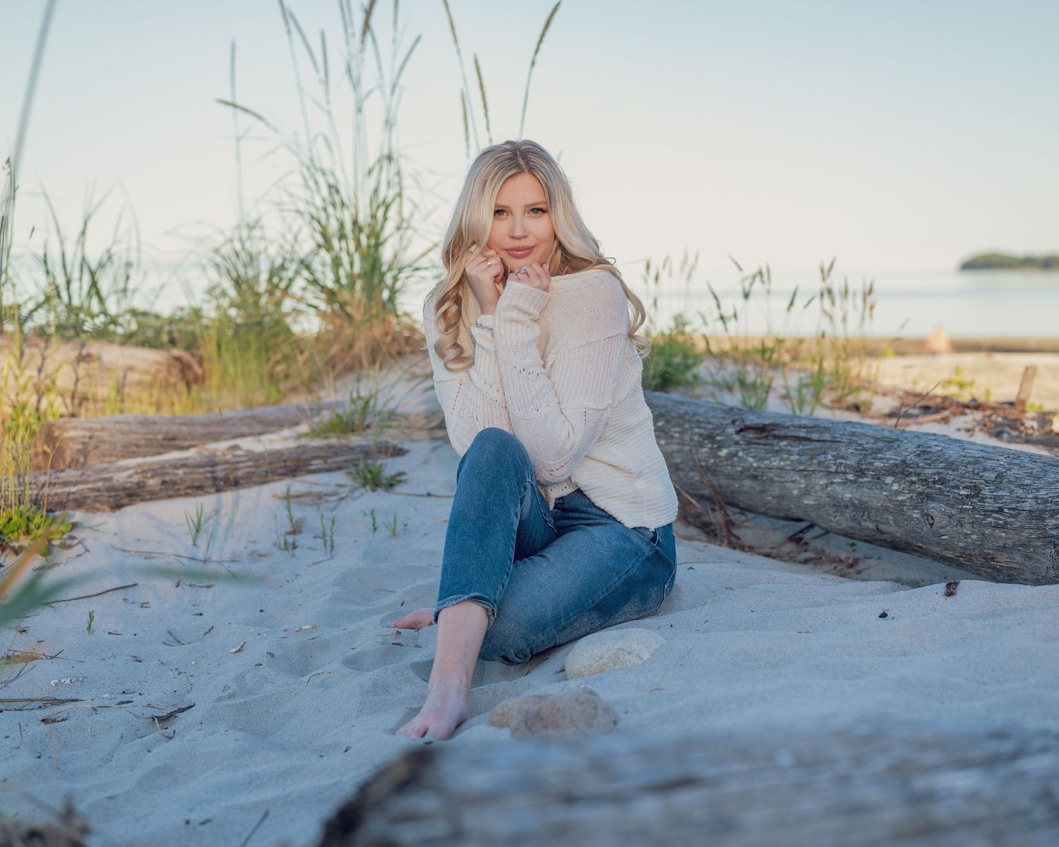 Photoshoot of beautiful women wearing sweater at the beach.