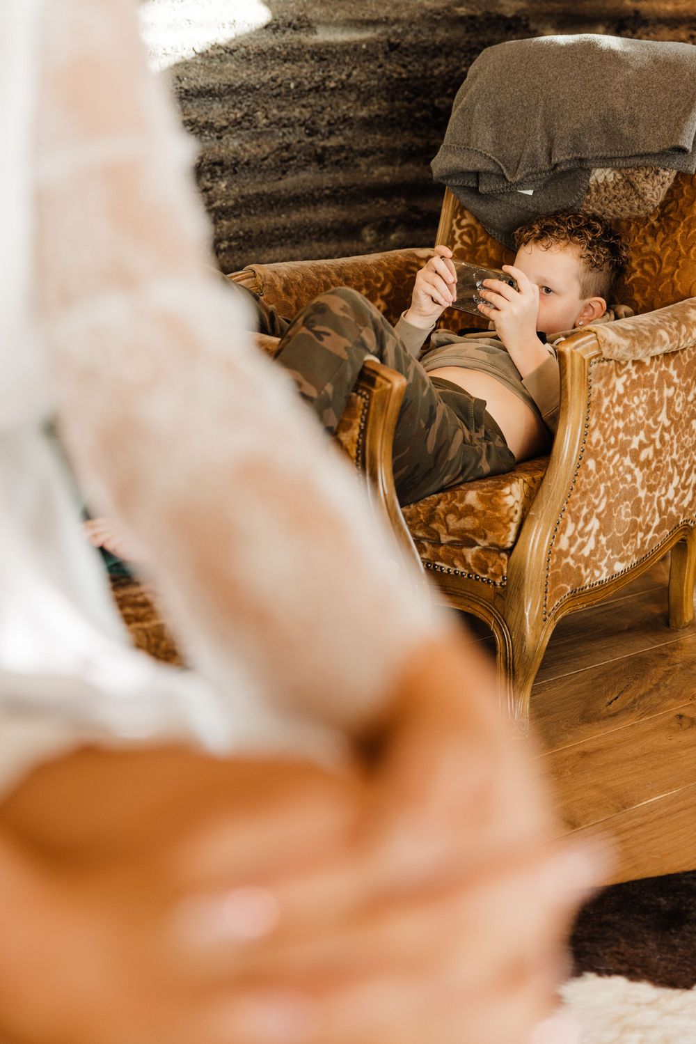 Cozy scene of someone resting on a vintage brown velvet armchair.