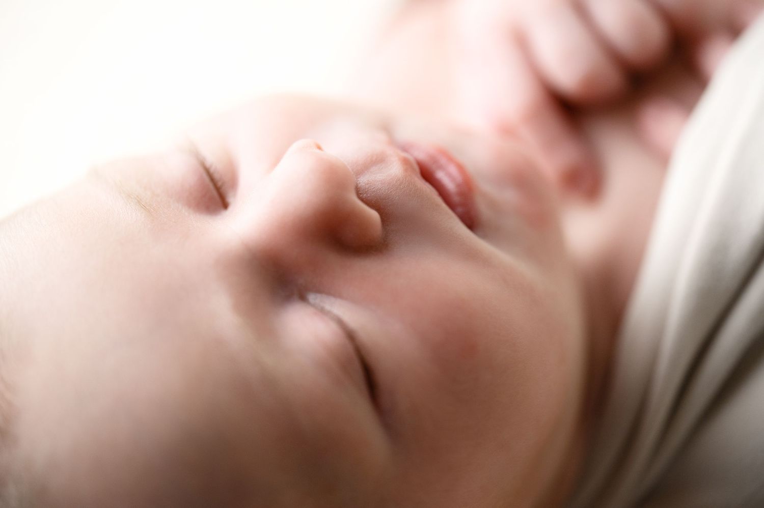 Artistic macro shot of sleeping baby with dreamy soft focus effect.