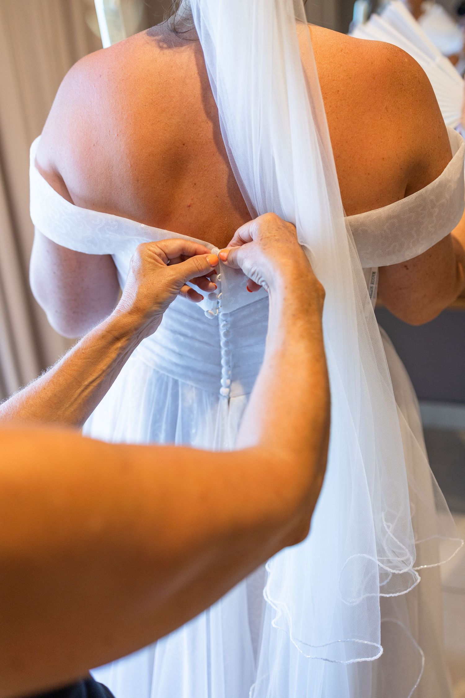 Bride getting in her dress