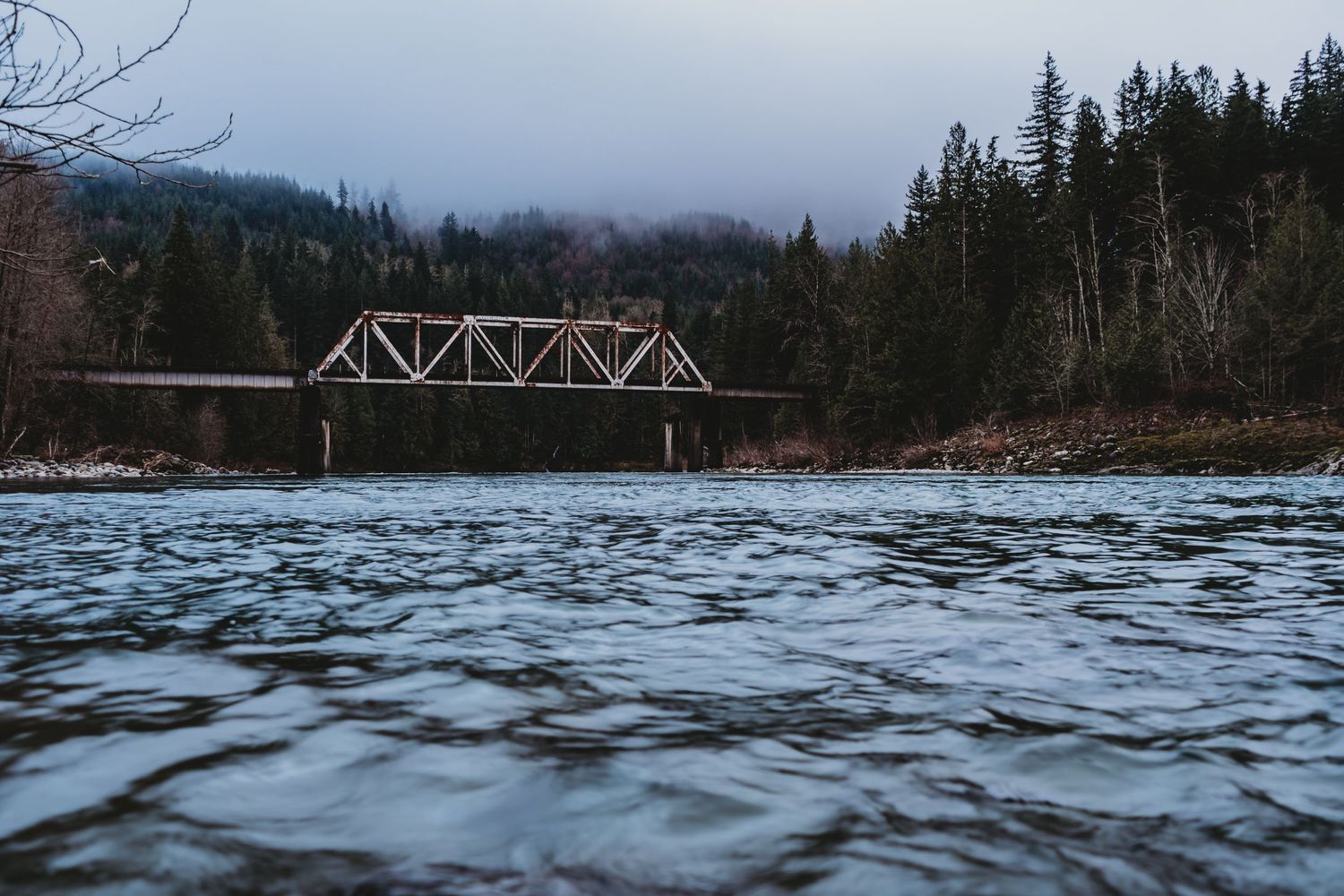 Railroad Bridge nestled above the Skykomish River nestled within Washingtons evergreens near Index, Washington