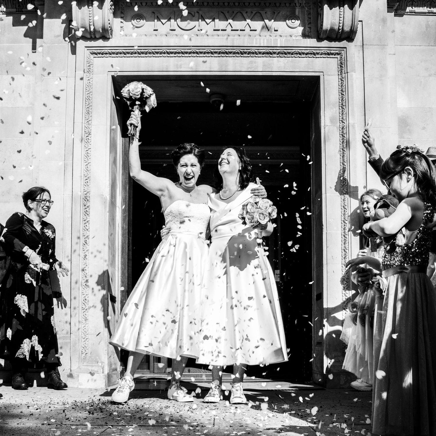 Same sex couple with confetti at Islington Town Hall