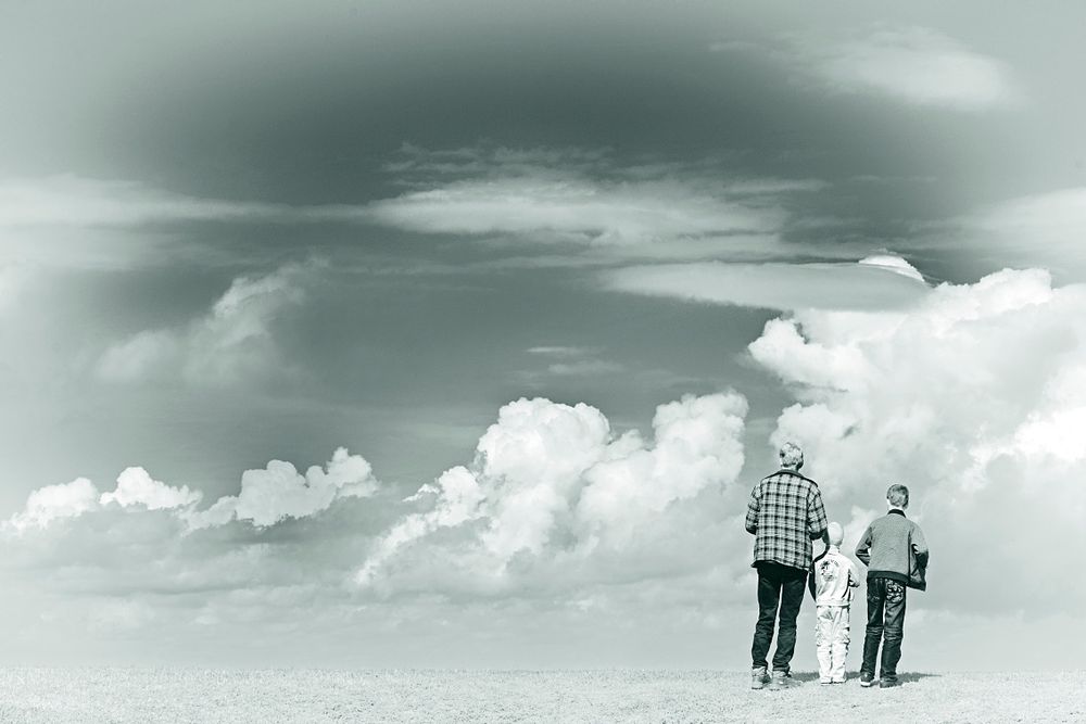 Father and sons watching the beautiful clouds