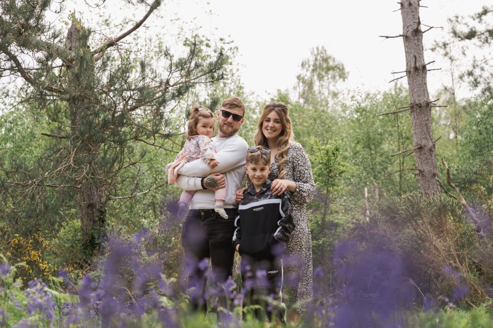photograph of a family of four photographed with lavender in the foreground