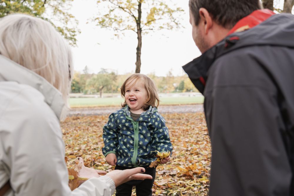 photograph of smiling boy between his parents