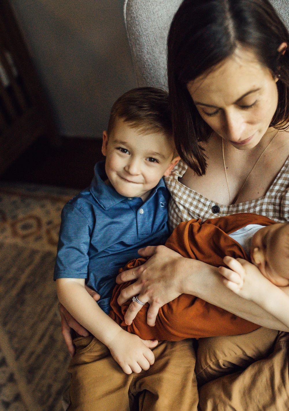 An intimate family moment captured indoors with soft natural lighting.