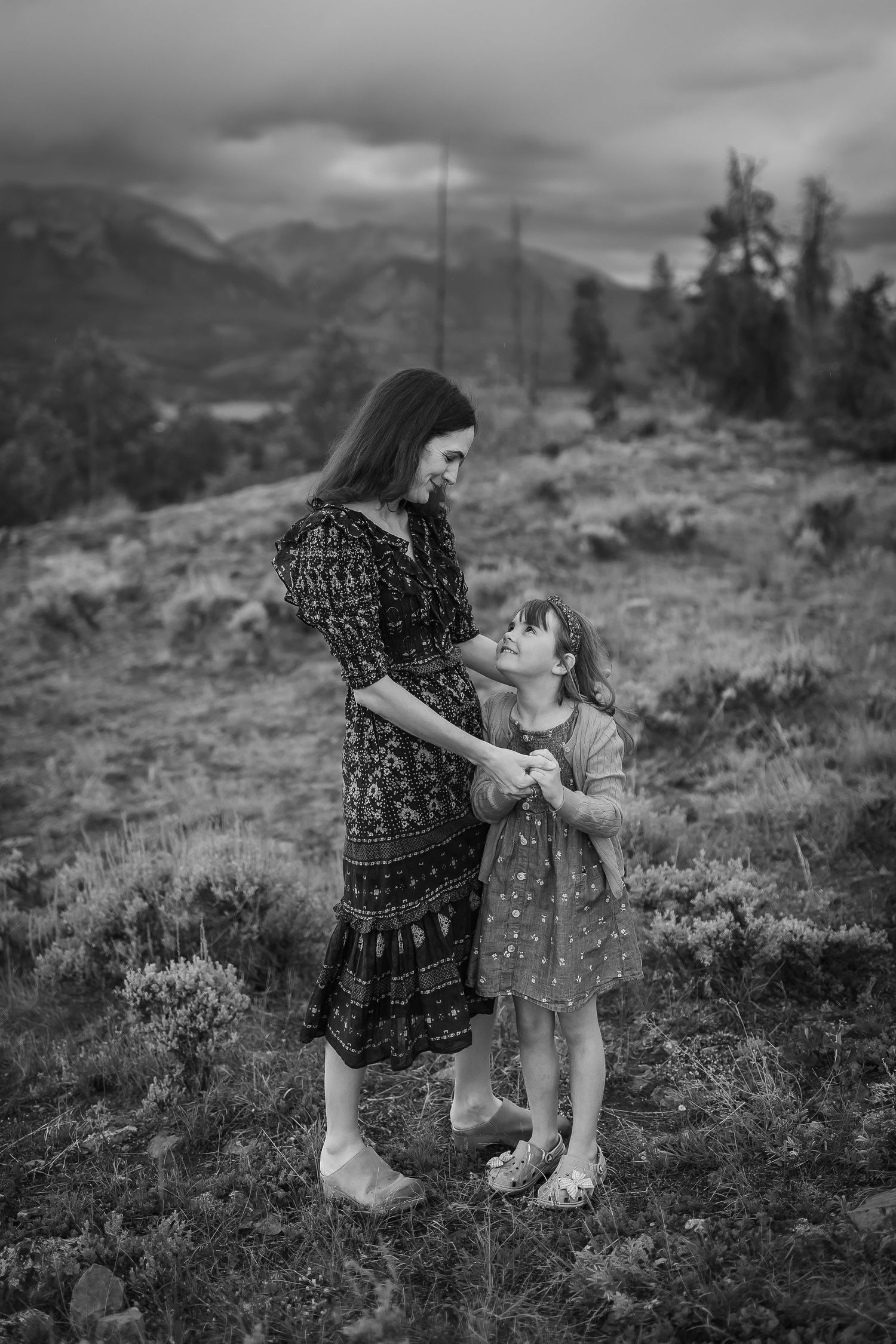 Black and white photography Mother smiling tenderly at child in Colorado mountains