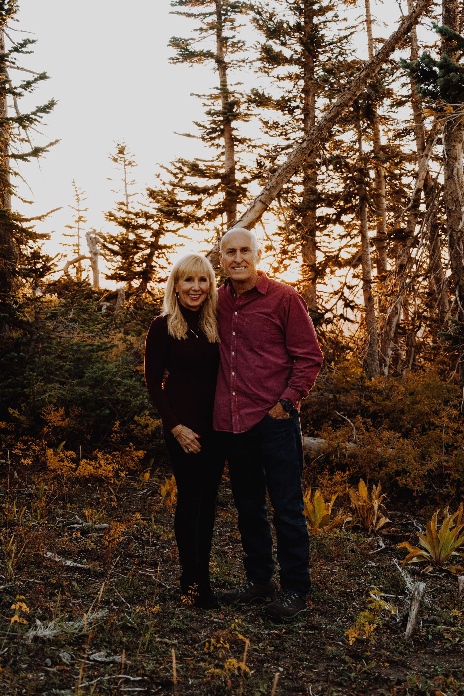 A warm and candid portrait of a couple/family, captured in natural light, with a timeless background.