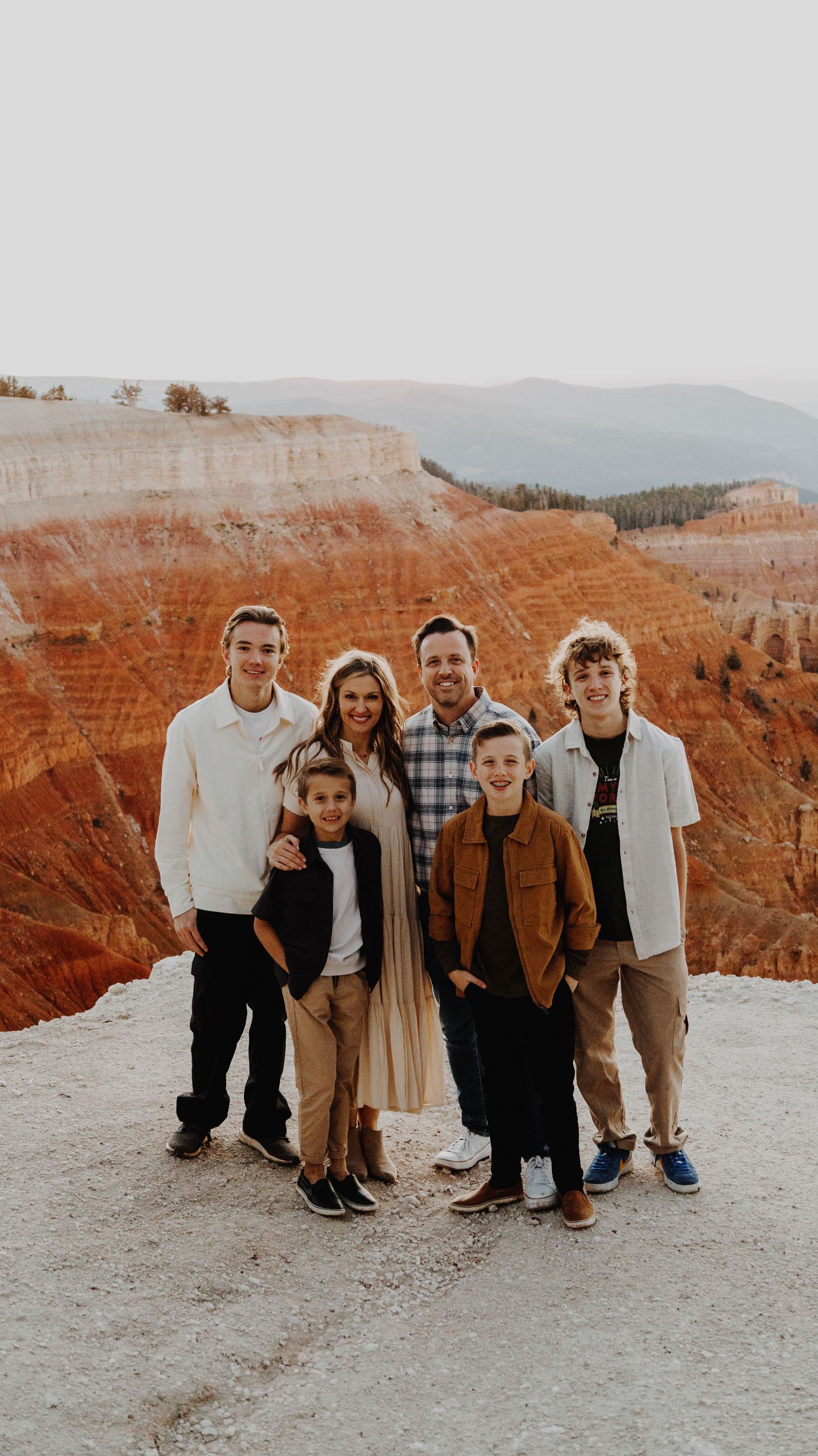 A warm and candid portrait of a couple/family, captured in natural light, with a timeless background.