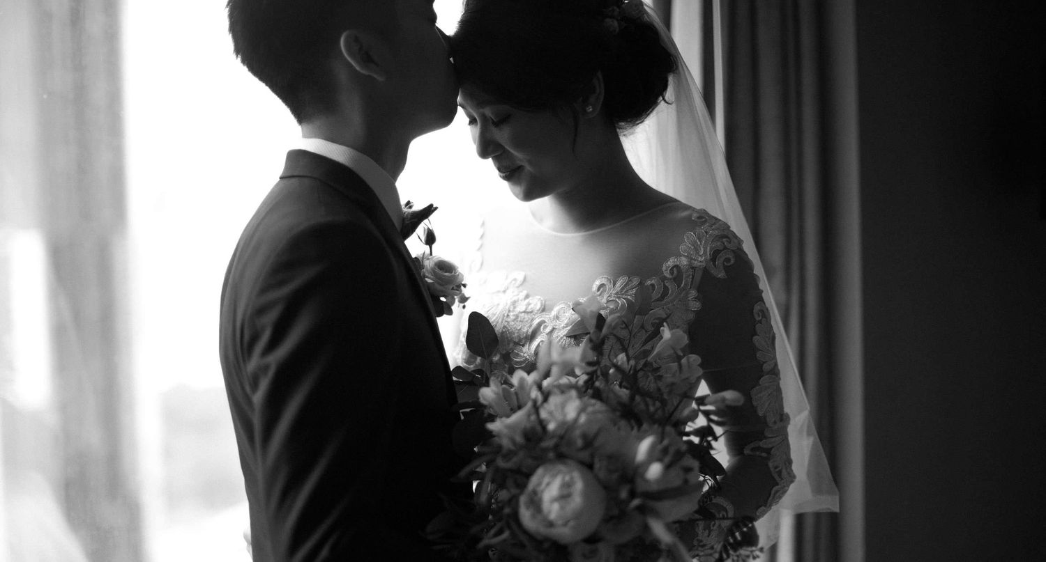 groom kissing his bride on their wedding day