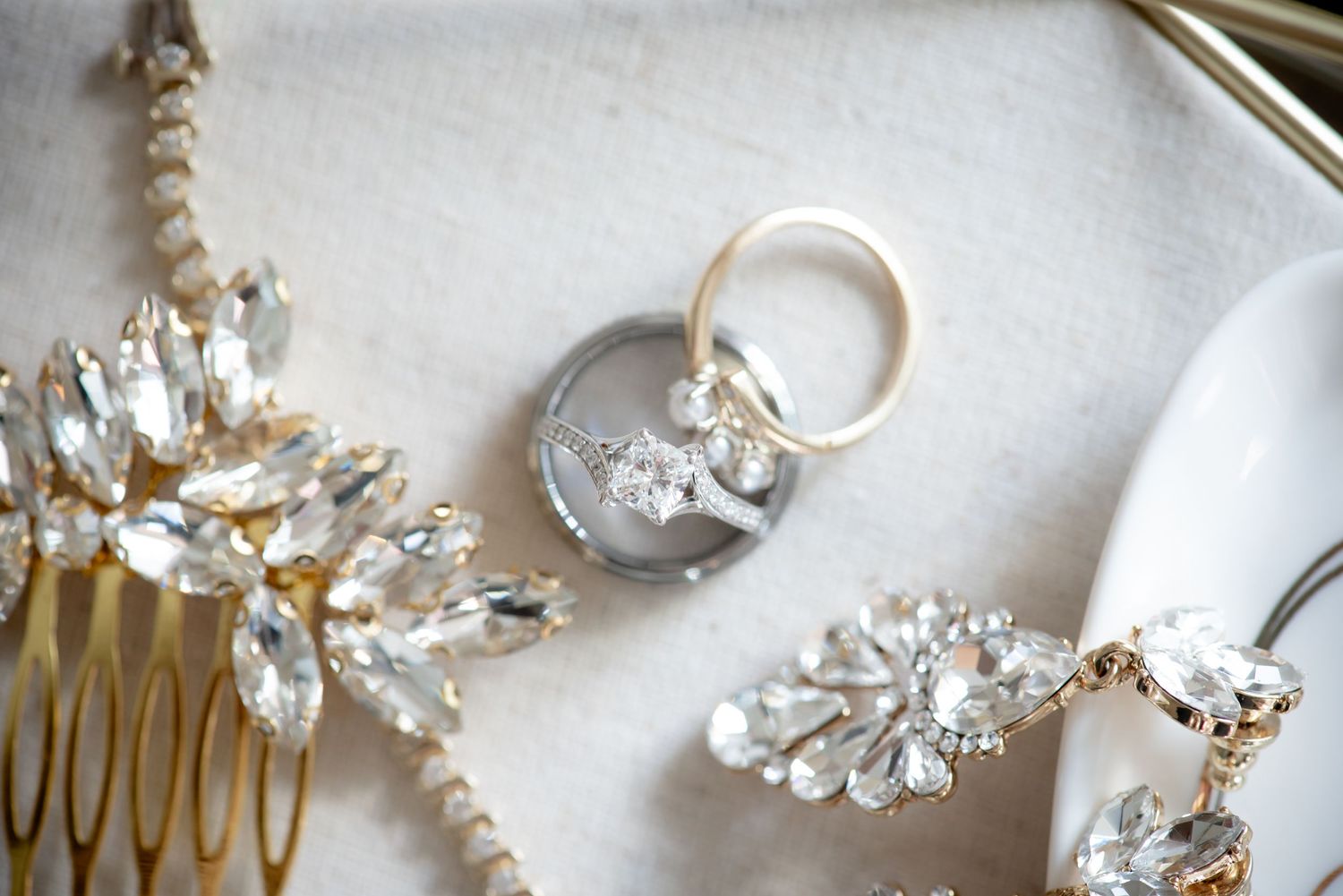 Wedding photo of the wedding rings and jewelry by Sacramento wedding photographer, Ashley Nicole Baeza.