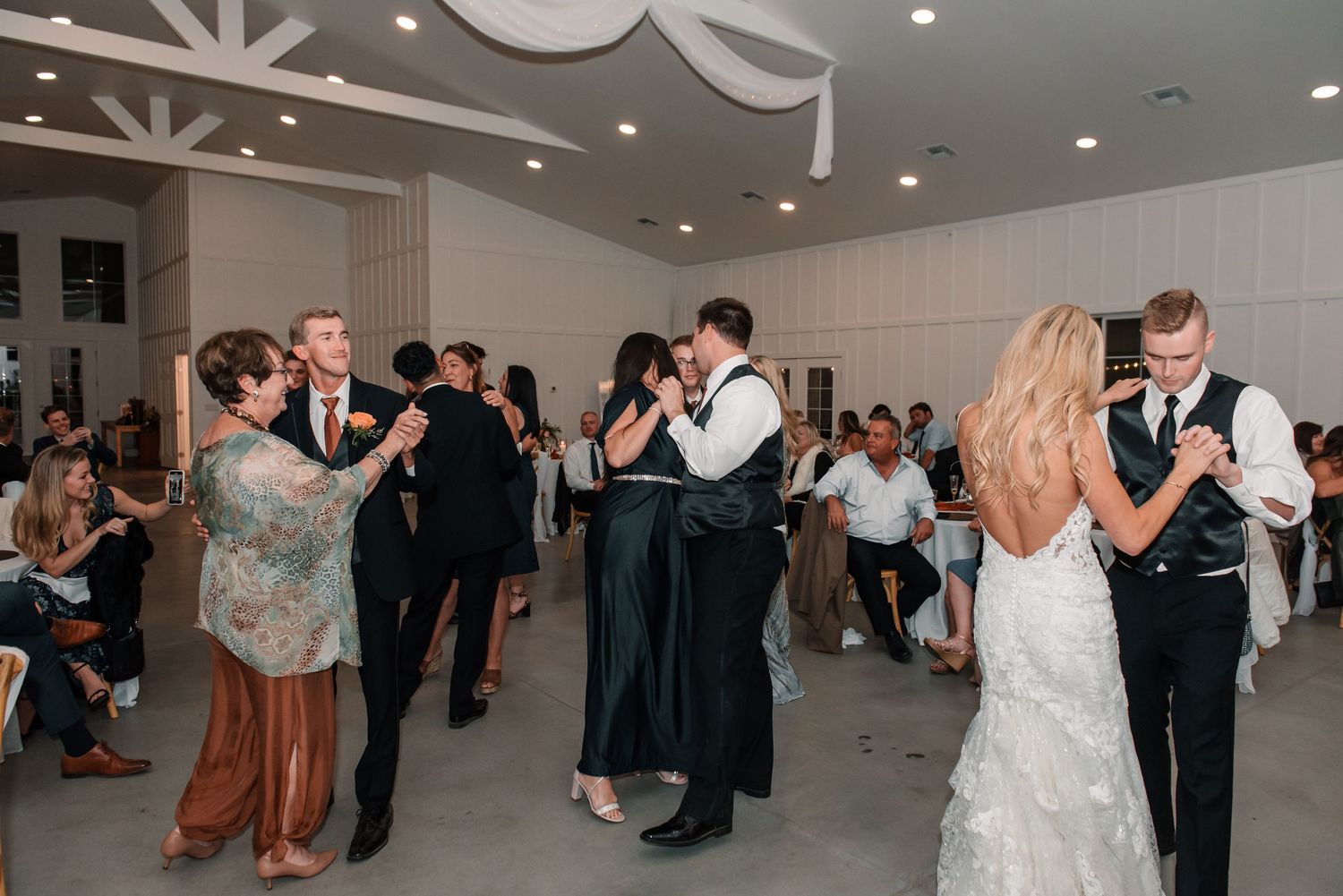Wedding reception dance floor filled with guests enjoying the celebration.